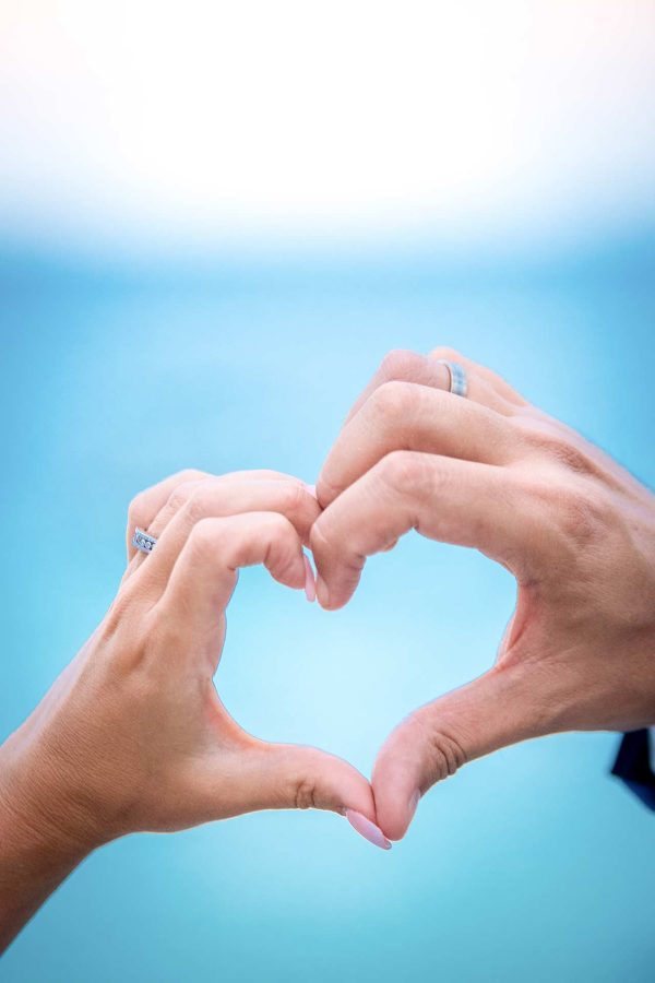 bride and groom forming a heart with hands