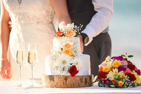 nice floral wedding cake cutting with champagne 