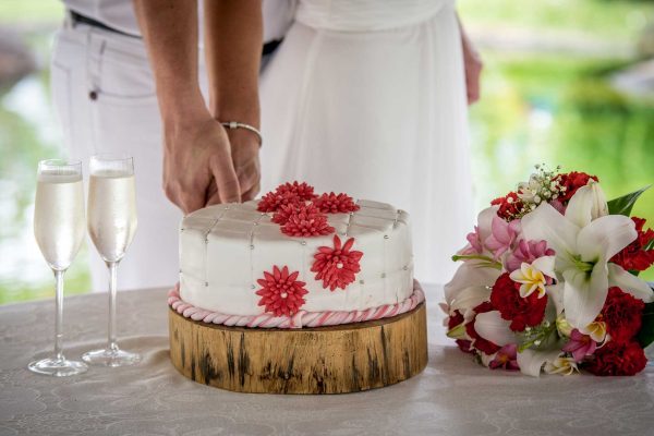 beautiful red wedding cake cutting with red flower