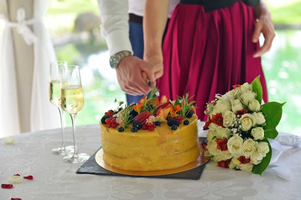 yellow wedding cake with berries and champagne