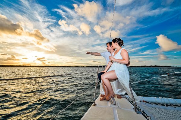 newly wedded couple posing on catamaran