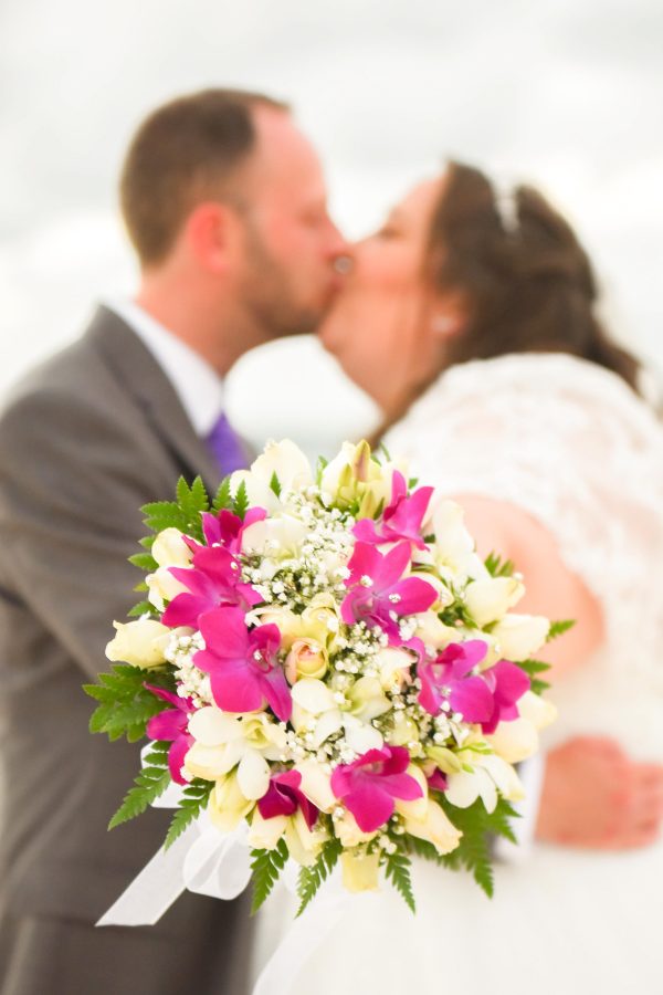 nice couple kissing on the white beach