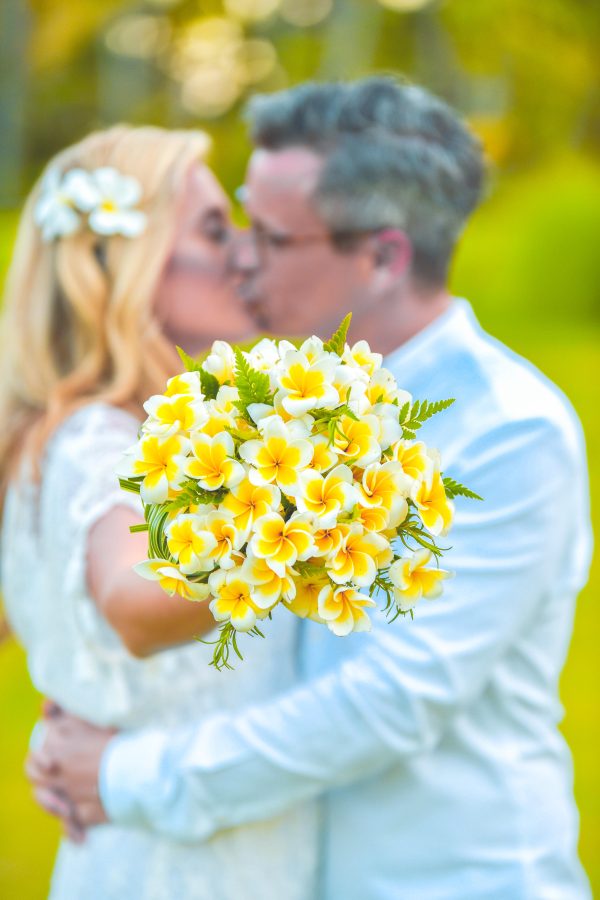 couple kissing in background