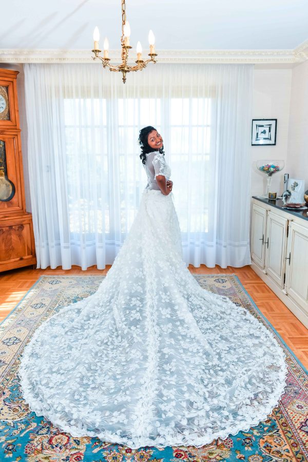 Bride dressed in white is posing before her wedding ceremony 
