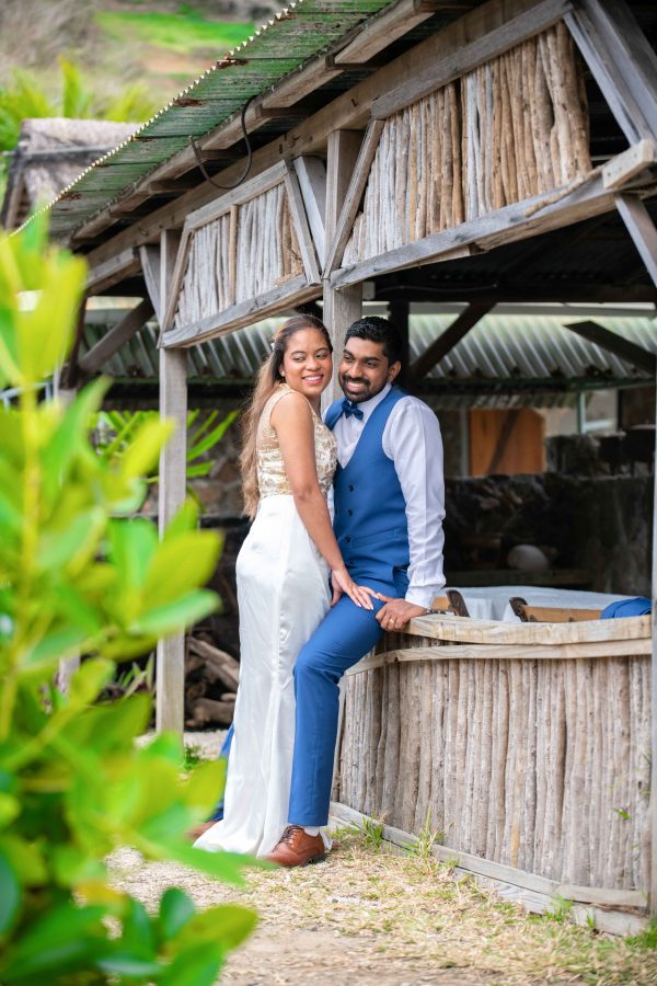 Couple posing near a hut in Mauritius 