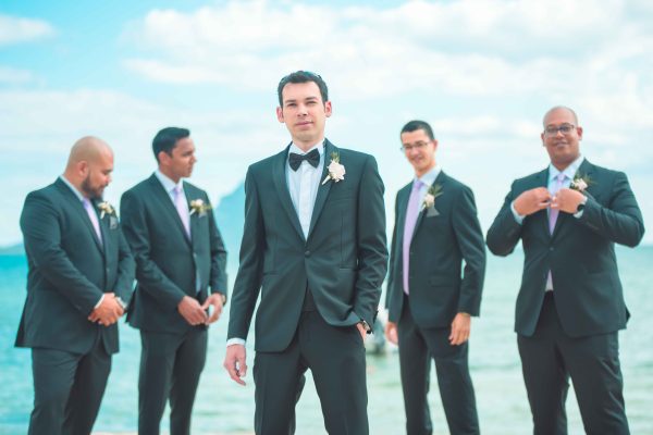 Groom and groomsmen posing at the beach in Mauritius 