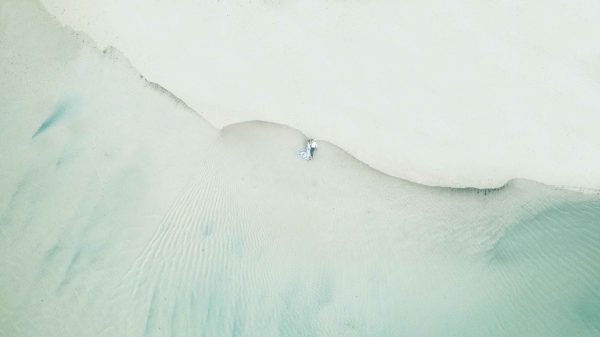 drone photo of couple on the beach of belle mare