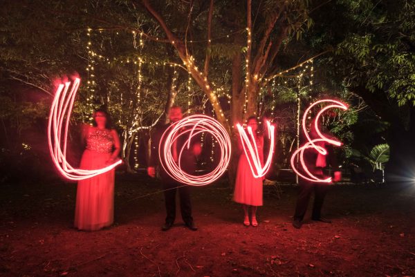 Long exposure shot of people writing love for wedding in Mauritius 